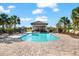 Community pool and cabana area surrounded by lounge chairs and lush landscaping for outdoor relaxation at 5537 Palmer Cir # 205, Lakewood Ranch, FL 34211
