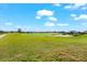 Scenic view of the well-manicured golf course with a serene lake in the distance under a partly cloudy sky at 5537 Palmer Cir # 205, Lakewood Ranch, FL 34211