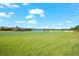 Expansive view of the lush golf course, blue sky and landscaping surrounding the beautiful community at 5537 Palmer Cir # 205, Lakewood Ranch, FL 34211