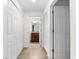Hallway view featuring closet doors, and tile flooring leading to a bathroom with wood vanity and granite countertop at 5537 Palmer Cir # 205, Lakewood Ranch, FL 34211