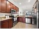 Modern kitchen with granite countertops, stainless steel appliances, and tile flooring at 5537 Palmer Cir # 205, Lakewood Ranch, FL 34211