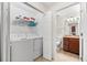 Bright laundry room with appliances, shelving, and access to the tiled bathroom, offering convenience and functionality at 5537 Palmer Cir # 205, Lakewood Ranch, FL 34211