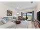 Light and airy living room showcasing comfortable seating, a ceiling fan, and sliding glass doors to the outside at 5537 Palmer Cir # 205, Lakewood Ranch, FL 34211