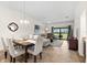 Open floor plan featuring a dining area and living room with a sliding glass door for outdoor access at 5537 Palmer Cir # 205, Lakewood Ranch, FL 34211
