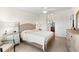 Main Bedroom featuring a ceiling fan, furnishings with a sunny window view and access to an ensuite bathroom at 5537 Palmer Cir # 205, Lakewood Ranch, FL 34211