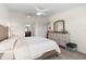 Main Bedroom featuring a ceiling fan, furnishings with a sunny window view and access to an ensuite bathroom at 5537 Palmer Cir # 205, Lakewood Ranch, FL 34211