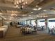 Spacious ballroom with tables set for an event, chandeliers, and large windows, ideal for celebrations at 5712 Cottonwood St, Bradenton, FL 34203