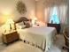 Comfortable bedroom with decorative wall art, lamps, and neutral color palette at 5712 Cottonwood St, Bradenton, FL 34203