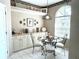 Cozy breakfast nook with a glass top table, bright window and built in cabinets at 5712 Cottonwood St, Bradenton, FL 34203