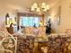 Cozy dining room with glass table, floral chairs, and view of the yard at 5712 Cottonwood St, Bradenton, FL 34203