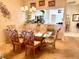 Dining room with glass table, floral chairs, and view of the kitchen at 5712 Cottonwood St, Bradenton, FL 34203