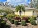 Well-manicured front yard with lush landscaping and a charming one-story home in the background at 5712 Cottonwood St, Bradenton, FL 34203