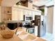 Well-equipped kitchen with stainless steel appliances, white cabinetry, and a practical layout at 5712 Cottonwood St, Bradenton, FL 34203