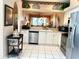 Well-designed kitchen with stainless steel appliances, white cabinets, and a breakfast bar view into living area at 5712 Cottonwood St, Bradenton, FL 34203