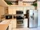 Well-equipped kitchen with stainless steel appliances, white cabinetry, and a practical layout at 5712 Cottonwood St, Bradenton, FL 34203