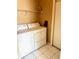 Functional laundry room with a side-by-side washer and dryer and storage shelf at 5712 Cottonwood St, Bradenton, FL 34203
