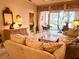 Cozy living area with plush sofa, glass coffee table, and view to the outdoor patio at 5712 Cottonwood St, Bradenton, FL 34203