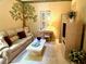 Inviting living room with cozy sofa, decorative tree art, and bright desk area at 5712 Cottonwood St, Bradenton, FL 34203