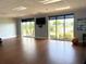 Bright yoga room with hardwood floors, large windows, and views of the lake at 5712 Cottonwood St, Bradenton, FL 34203
