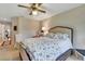 Bedroom with decorated queen bed and ceiling fan at 5729 Garden Lakes Palm, Bradenton, FL 34203