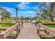 Beautiful lake view from a community dock with seating, perfect for relaxing and enjoying nature at 5729 Garden Lakes Palm, Bradenton, FL 34203