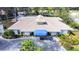 Aerial view of home featuring a light-colored exterior, tile roof, and a blue porch cover at 5729 Garden Lakes Palm, Bradenton, FL 34203