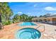 Resort-style pool area featuring a hot tub and sun loungers, perfect for relaxation at 574 Crane Prairie Way, Osprey, FL 34229