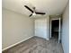 This is a carpeted bedroom with a closet and ceiling fan at 5852 Ocean Isle Dr, Nokomis, FL 34275