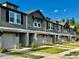 New construction townhomes featuring attached garages and manicured landscaping at 5852 Ocean Isle Dr, Nokomis, FL 34275