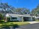 Charming single-story home featuring a covered carport and well-maintained lawn at 6025 Hibiscus Dr, Bradenton, FL 34207