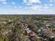Aerial view of the house with a red location pin, highlighting its position in a lush neighborhood at 604 68Th Avenue W Dr, Bradenton, FL 34207
