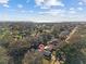 Aerial view of the house, emphasizing its location in a tree-filled neighborhood near the waterfront at 604 68Th Avenue W Dr, Bradenton, FL 34207