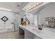 Well-lit bathroom with a skylight, double vanity, and separate tub and shower at 604 68Th Avenue W Dr, Bradenton, FL 34207