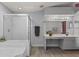 Bathroom featuring a glass shower, soaking tub, and vanity area at 604 68Th Avenue W Dr, Bradenton, FL 34207