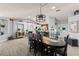 Bright dining room with a large table and modern light fixture at 604 68Th Avenue W Dr, Bradenton, FL 34207