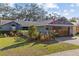 Charming single-story home features a two-car garage, well-manicured lawn, and lush landscaping at 604 68Th Avenue W Dr, Bradenton, FL 34207