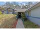 Charming home with well-maintained landscaping along the walkway to the front door at 604 68Th Avenue W Dr, Bradenton, FL 34207