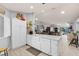 Open-concept kitchen features a farmhouse sink, white cabinetry and views into the living space at 604 68Th Avenue W Dr, Bradenton, FL 34207