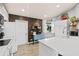 Well-lit kitchen featuring a center island with quartz countertop and a rustic wood accent wall at 604 68Th Avenue W Dr, Bradenton, FL 34207