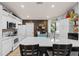 Bright kitchen features white cabinets, a center island, and rustic wood accents for a modern farmhouse feel at 604 68Th Avenue W Dr, Bradenton, FL 34207