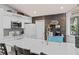Bright kitchen with white cabinets, stainless steel appliances, large island and stylish backsplash at 604 68Th Avenue W Dr, Bradenton, FL 34207