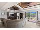 Cozy living room featuring a large sectional couch and backyard views at 604 68Th Avenue W Dr, Bradenton, FL 34207