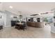 Open-concept living area with a large sectional sofa and stylish decor at 604 68Th Avenue W Dr, Bradenton, FL 34207