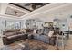 Open-concept living room is filled with natural light, a large sectional sofa, and stylish decor at 604 68Th Avenue W Dr, Bradenton, FL 34207
