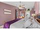 Comfortable main bedroom with ceiling fan, decorative wall hangings, and access to the ensuite bathroom at 604 68Th Avenue W Dr, Bradenton, FL 34207