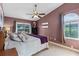 Comfortable main bedroom with ceiling fan, slider to the pool, and a large arched window at 604 68Th Avenue W Dr, Bradenton, FL 34207