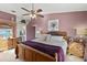 Serene main bedroom with soft lighting, a ceiling fan, wood furniture, and an ensuite bathroom at 604 68Th Avenue W Dr, Bradenton, FL 34207