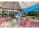 Outdoor patio with canopy, furnished with glass-top table and chairs, great for entertaining guests at 604 68Th Avenue W Dr, Bradenton, FL 34207