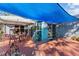 Inviting patio with overhead blue shade, furnished with dining set, creating the ideal relaxation space at 604 68Th Avenue W Dr, Bradenton, FL 34207