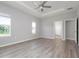 The main bedroom is spacious with wood-look floors, large windows, and neutral paint at 6506 166Th E Pl, Parrish, FL 34219